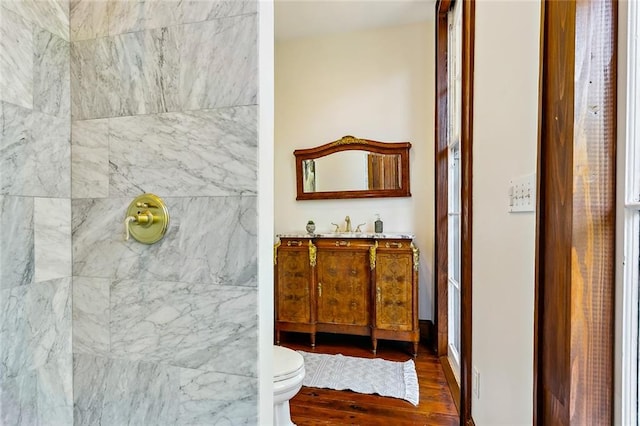 bathroom with hardwood / wood-style floors, vanity, and toilet