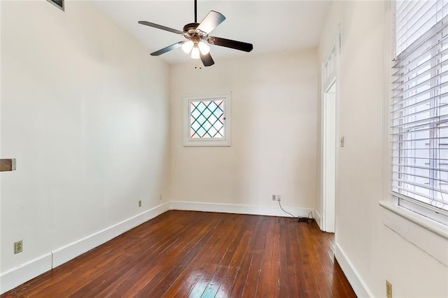 unfurnished room featuring dark wood-type flooring, ceiling fan, and plenty of natural light