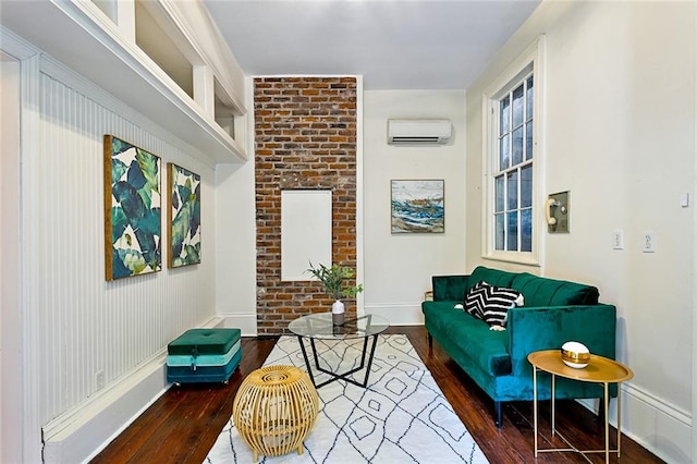 living area featuring dark wood-type flooring and a wall unit AC