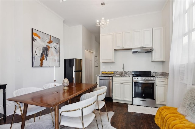 kitchen with white cabinets, stainless steel appliances, dark hardwood / wood-style floors, and light stone countertops