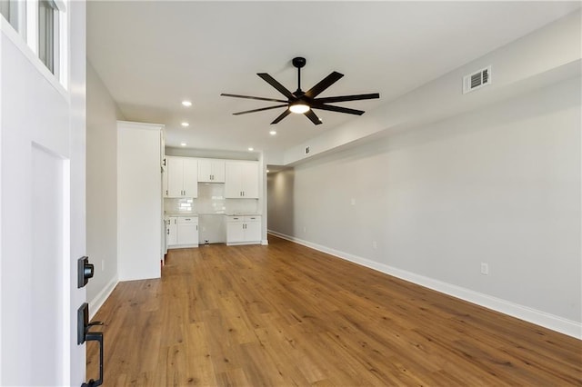 unfurnished living room with ceiling fan and light hardwood / wood-style flooring