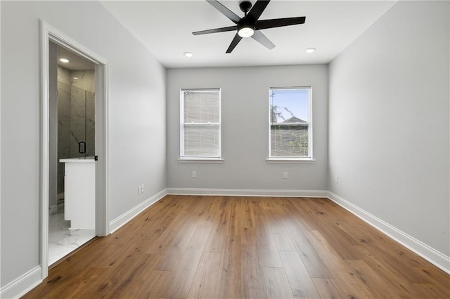 empty room featuring hardwood / wood-style flooring and ceiling fan