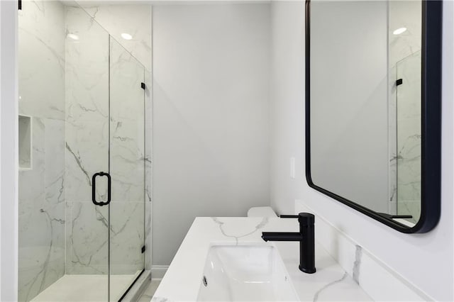 bathroom with vanity, a shower with shower door, and toilet