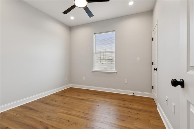 empty room with hardwood / wood-style flooring and ceiling fan