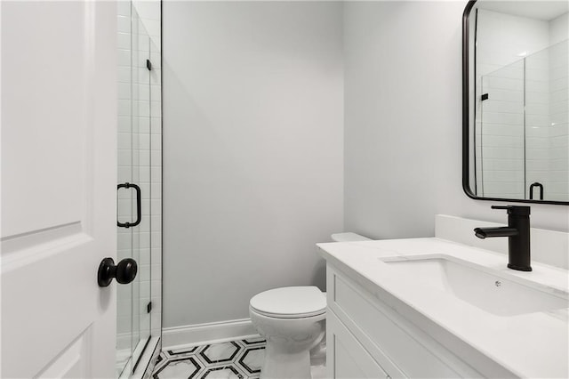 bathroom with walk in shower, vanity, and toilet