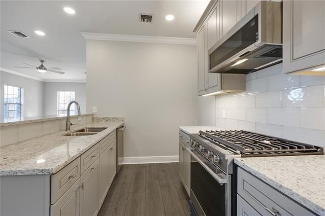 kitchen with dark hardwood / wood-style floors, stainless steel appliances, gray cabinetry, sink, and crown molding