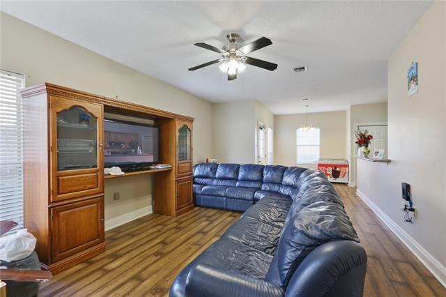 living room featuring ceiling fan and dark hardwood / wood-style flooring