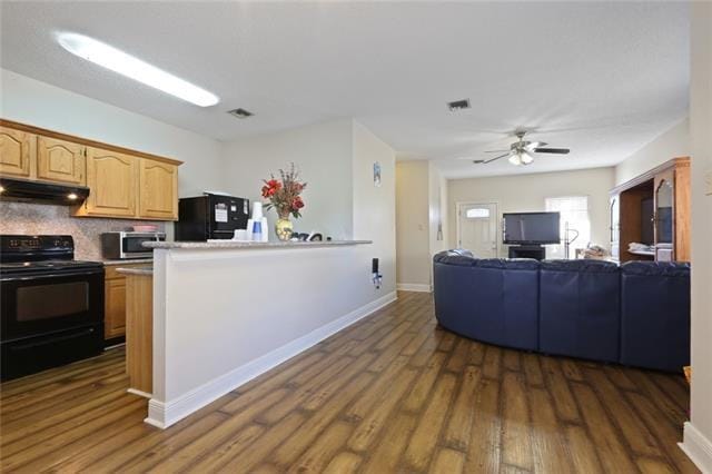 kitchen with dark wood-type flooring, backsplash, black appliances, and ceiling fan