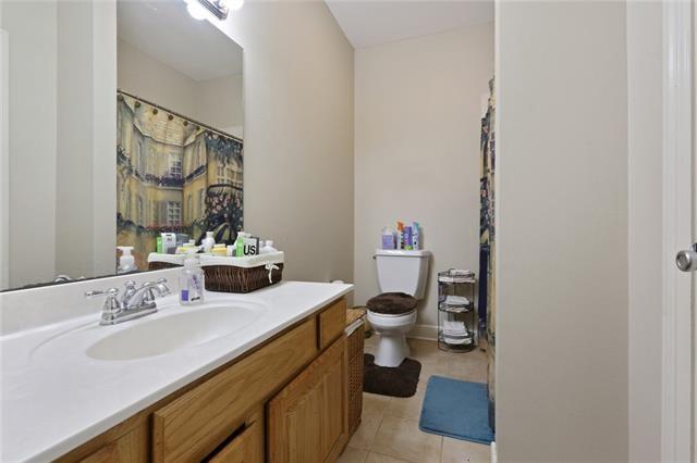 bathroom featuring tile patterned floors, vanity, and toilet