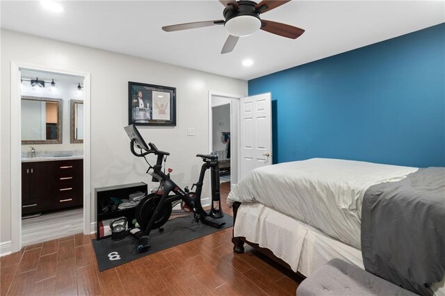 bedroom featuring ceiling fan, hardwood / wood-style flooring, sink, and ensuite bathroom