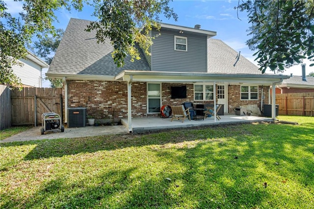 back of house with a yard and a patio area