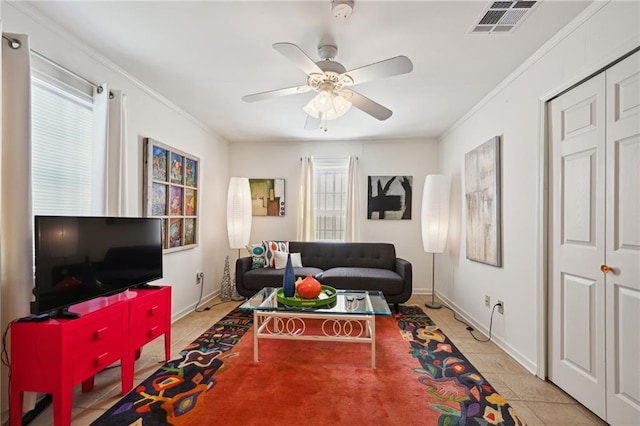 living room featuring ceiling fan, light tile patterned floors, and ornamental molding