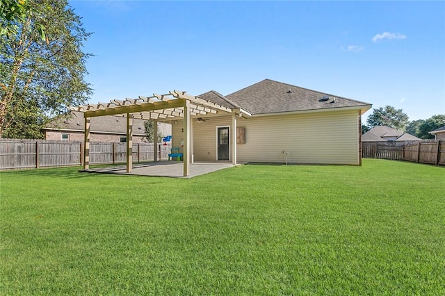 rear view of house featuring a pergola, a patio, and a lawn