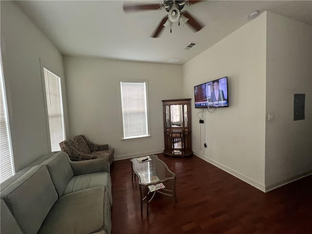 living room with ceiling fan and dark wood-type flooring