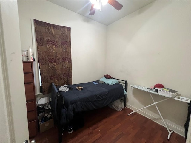 bedroom with ceiling fan and dark hardwood / wood-style flooring