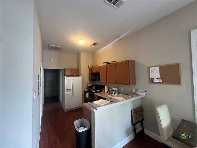 kitchen featuring kitchen peninsula, dark hardwood / wood-style floors, and black appliances