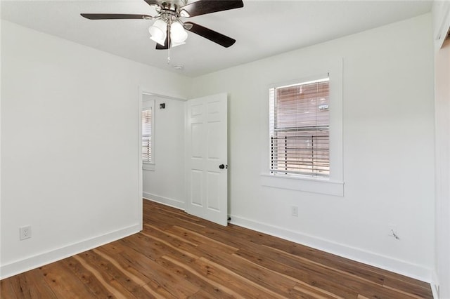 empty room featuring dark hardwood / wood-style flooring and ceiling fan