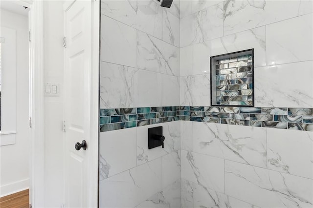 bathroom with tiled shower