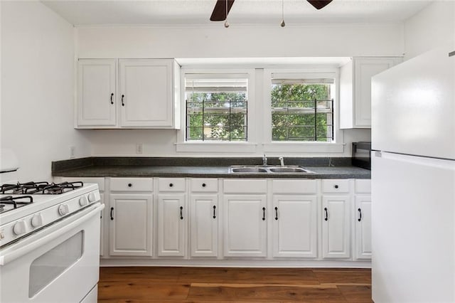 kitchen featuring ceiling fan, white appliances, dark hardwood / wood-style flooring, sink, and white cabinetry