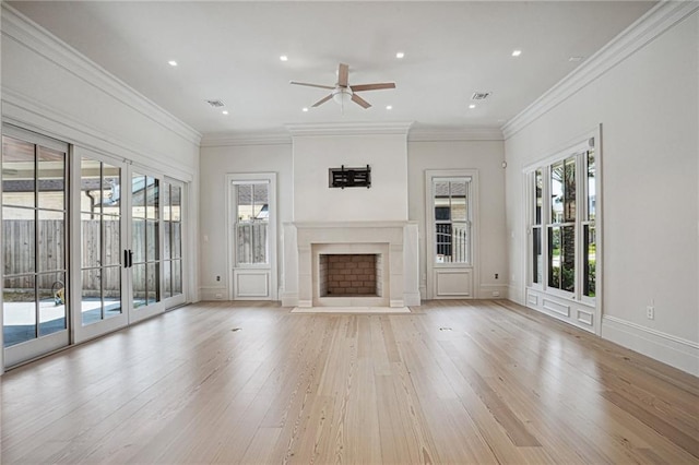 unfurnished living room featuring crown molding, a fireplace with flush hearth, and light wood-style floors