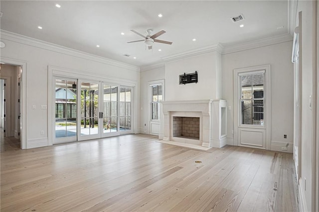 unfurnished living room with ceiling fan, ornamental molding, french doors, and light hardwood / wood-style floors