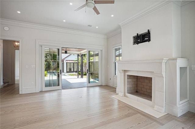 unfurnished living room with ceiling fan, light wood-type flooring, and crown molding