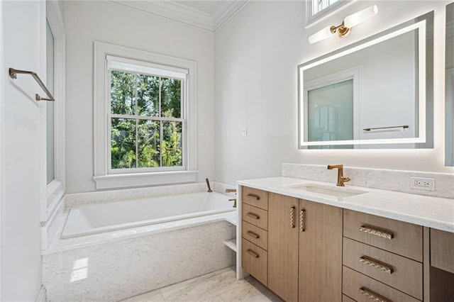 full bath featuring a garden tub, ornamental molding, and vanity