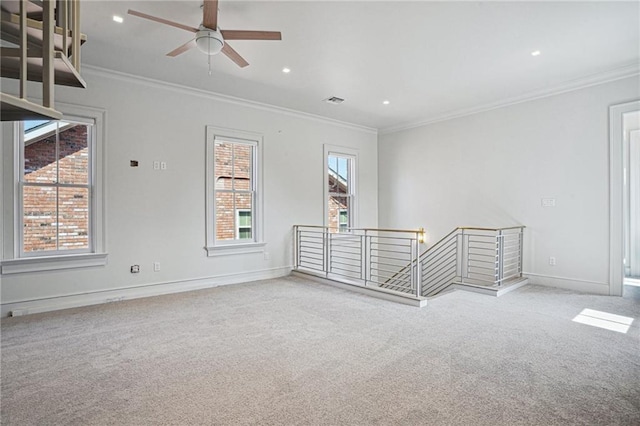 carpeted spare room featuring visible vents, baseboards, ceiling fan, crown molding, and recessed lighting