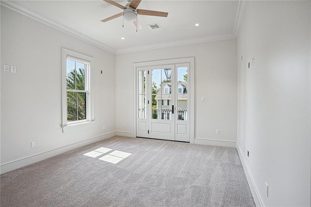 unfurnished room featuring light carpet, baseboards, visible vents, and crown molding