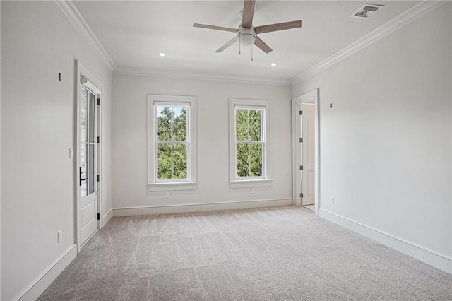 carpeted spare room with crown molding and ceiling fan