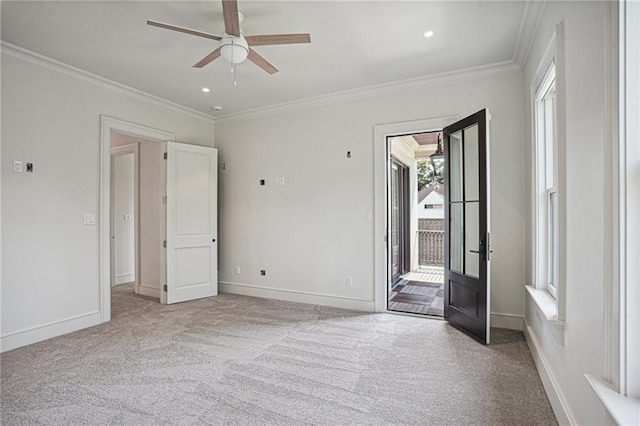 spare room featuring ornamental molding, light colored carpet, and ceiling fan