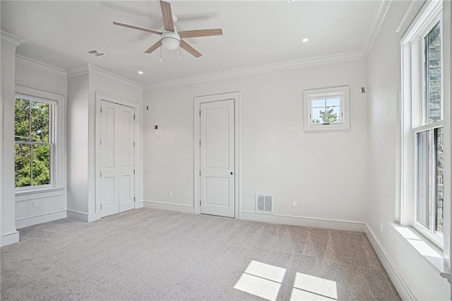 unfurnished bedroom with baseboards, carpet floors, visible vents, and crown molding