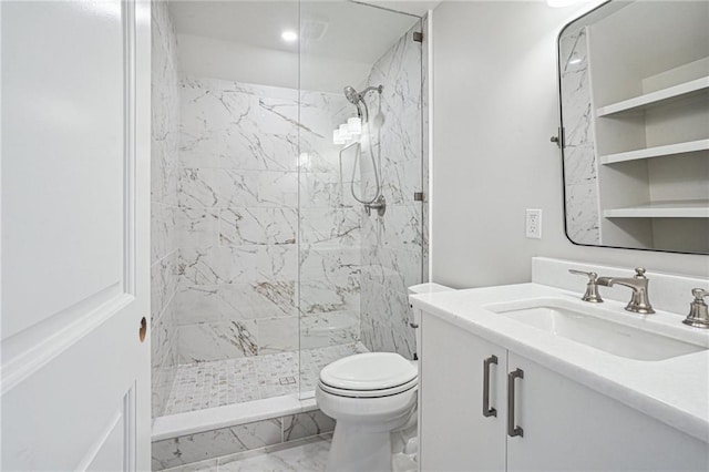 bathroom featuring tiled shower, vanity, and toilet