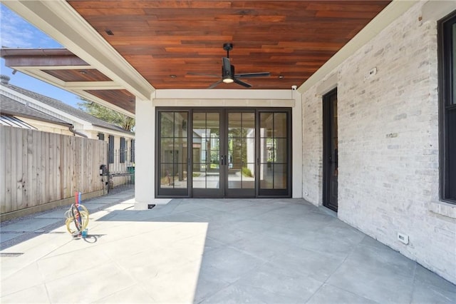 view of patio / terrace featuring a ceiling fan, french doors, and fence