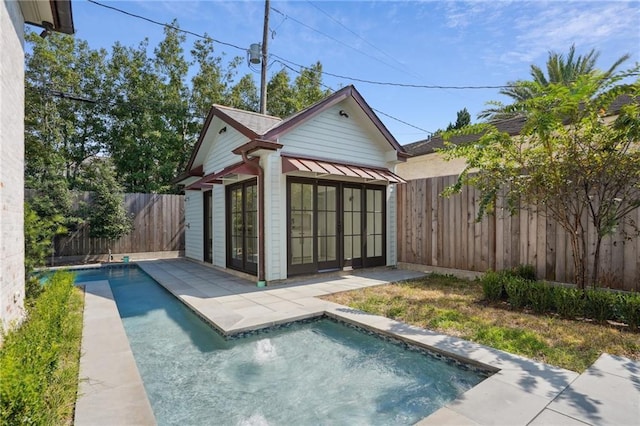 back of property with a fenced in pool, a patio, a fenced backyard, a storage structure, and an outdoor structure