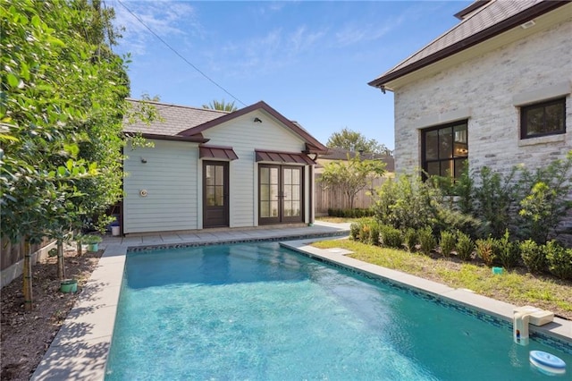 view of pool featuring french doors