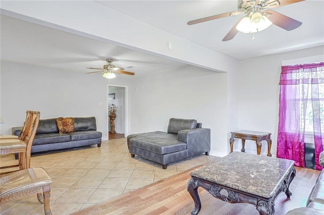 living room with light hardwood / wood-style floors and ceiling fan