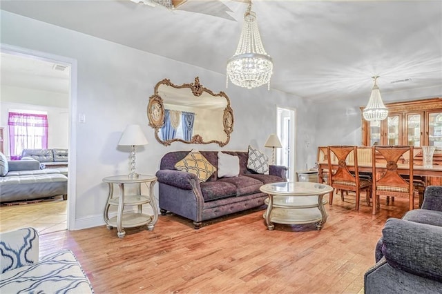 living room with wood-type flooring and a chandelier