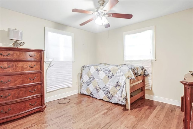 bedroom with light hardwood / wood-style flooring and ceiling fan