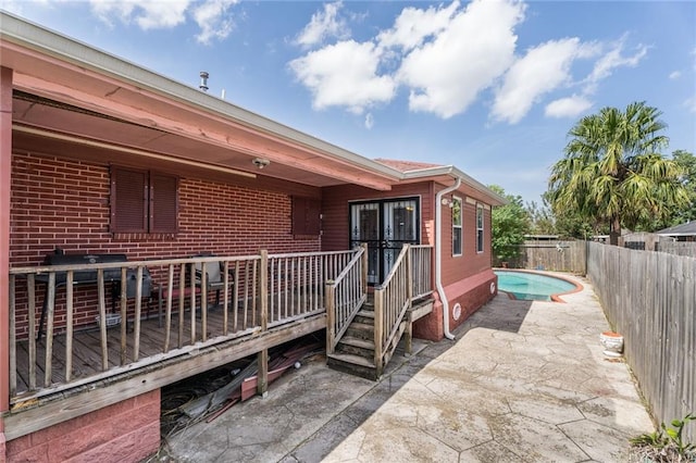 exterior space with a patio and a wooden deck