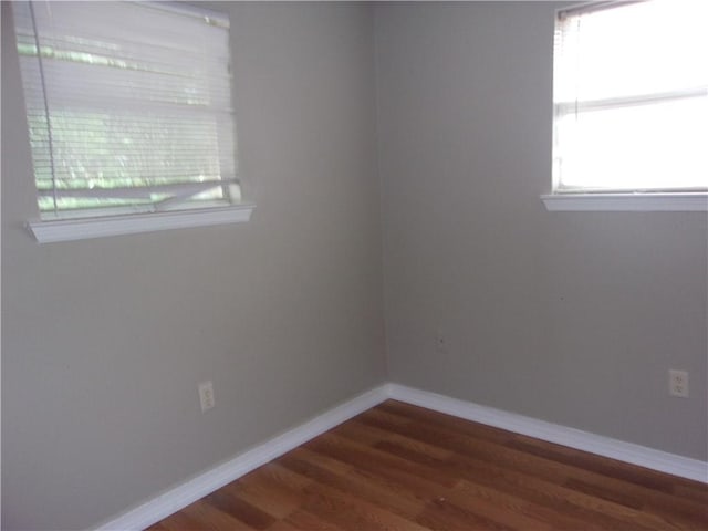 empty room featuring dark wood-type flooring