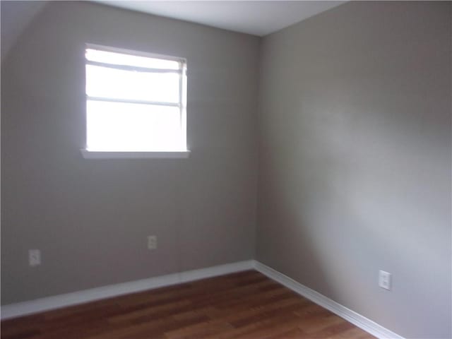 empty room featuring dark wood-type flooring