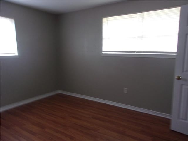 unfurnished room featuring dark wood-type flooring