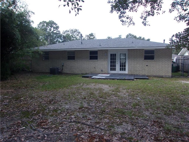 back of property with central AC unit and french doors