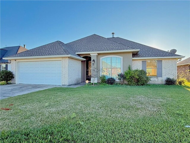 single story home with a front yard and a garage