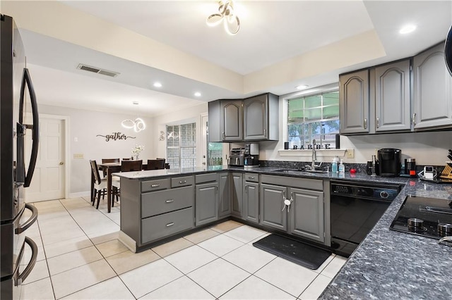 kitchen with light tile patterned floors, sink, kitchen peninsula, black appliances, and gray cabinets