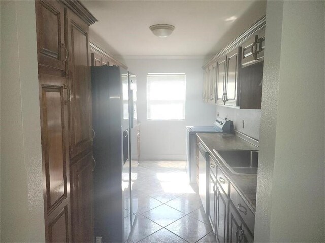 336 Indian Village Rd Unit 7, Slidell, LA 70461 - laundry area featuring a sink, light tile patterned flooring, crown molding, and a textured wall