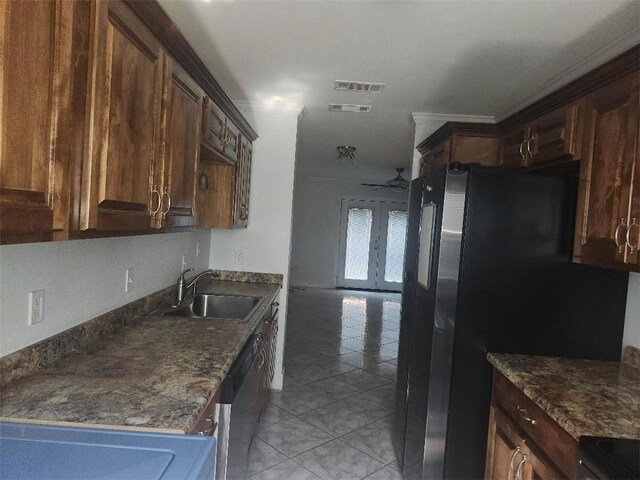 336 Indian Village Rd Unit 7, Slidell, LA 70461 - kitchen featuring a sink, light tile patterned floors, dark countertops, freestanding refrigerator, and dark brown cabinetry