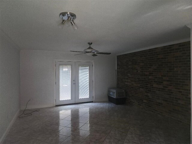 336 Indian Village Rd Unit 7, Slidell, LA 70461 - tiled empty room featuring french doors, a textured ceiling, a ceiling fan, brick wall, and baseboards