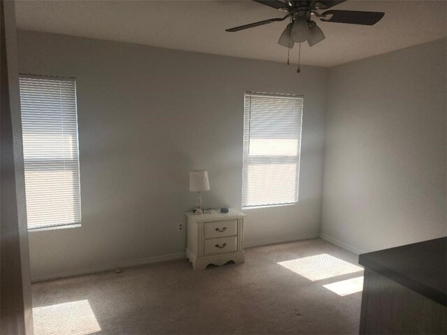 336 Indian Village Rd Unit 7, Slidell, LA 70461 - carpeted empty room featuring plenty of natural light, ceiling fan, and baseboards